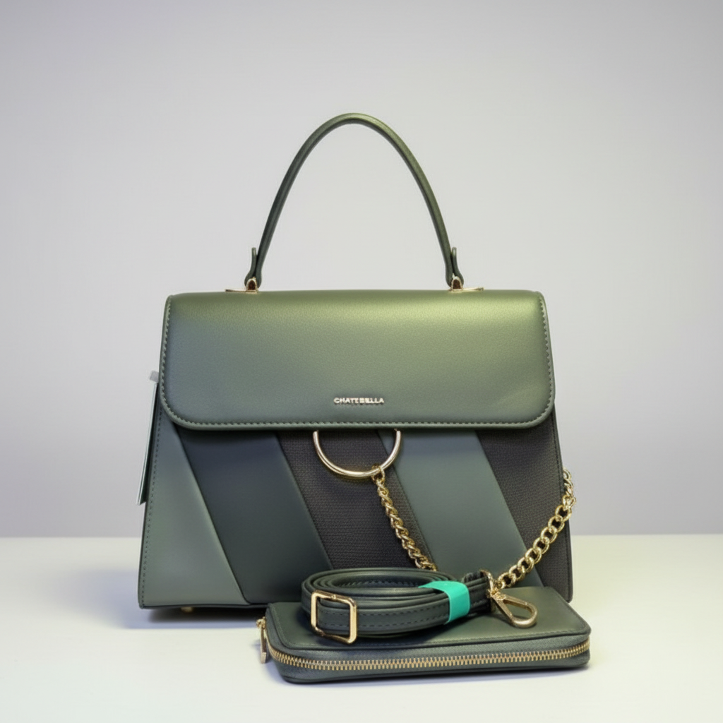 Green handbag with gold chain and matching belt on grass