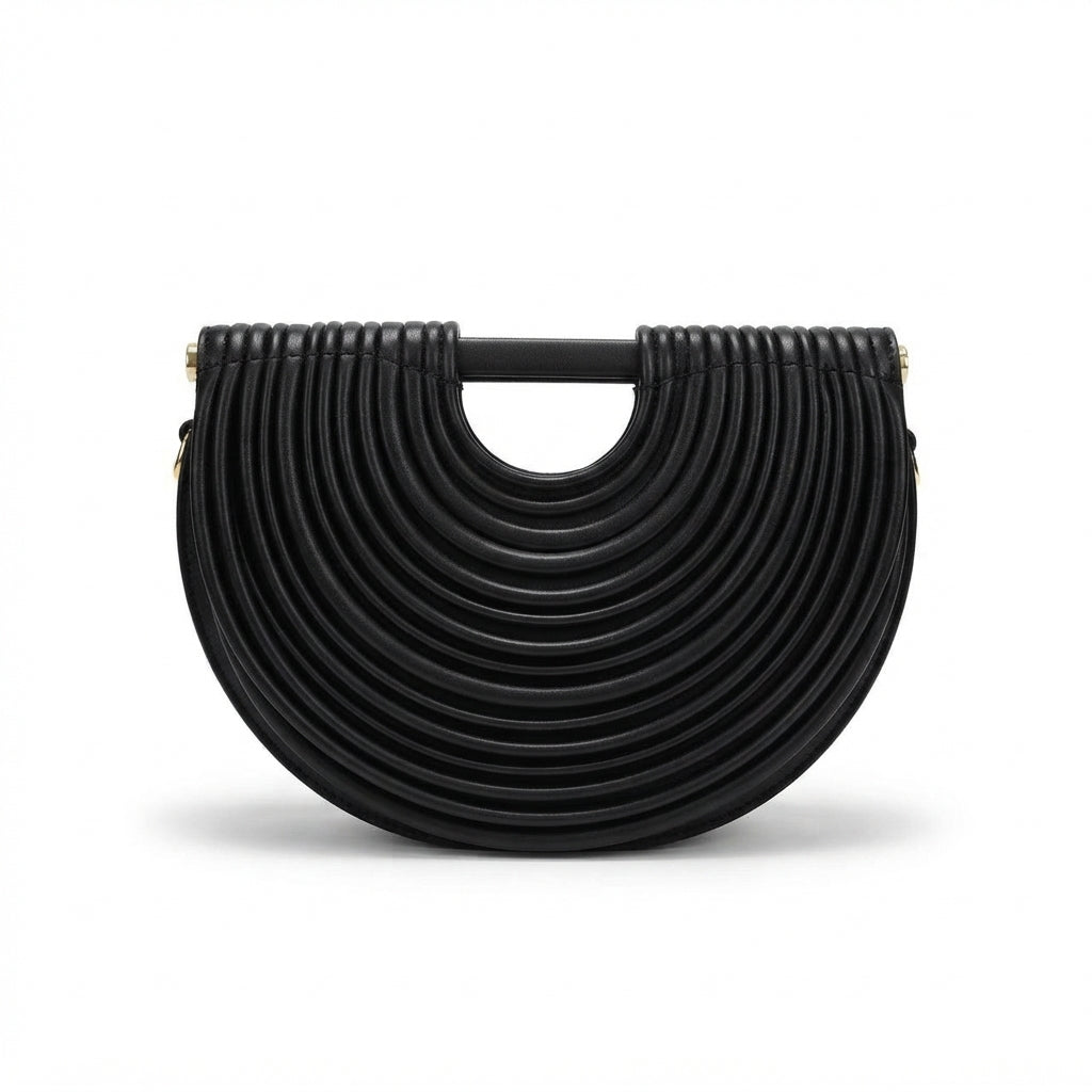 A black leather crescent-shaped handbag with a unique concentric circular pleated design and a top handle, shown on a plain white background.