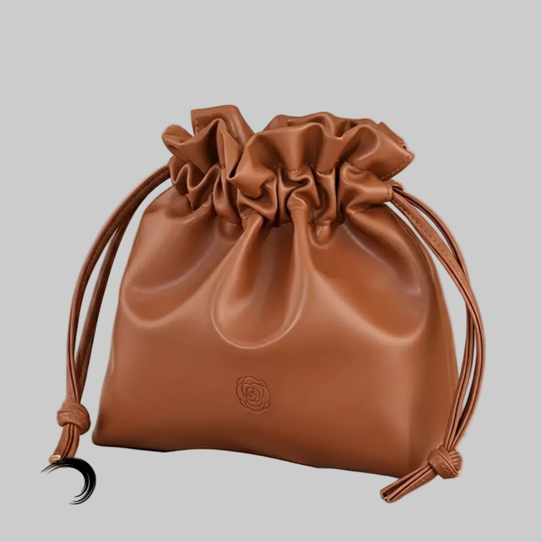 Brown drawstring bag on a light pink background with 'Boundless' branding.