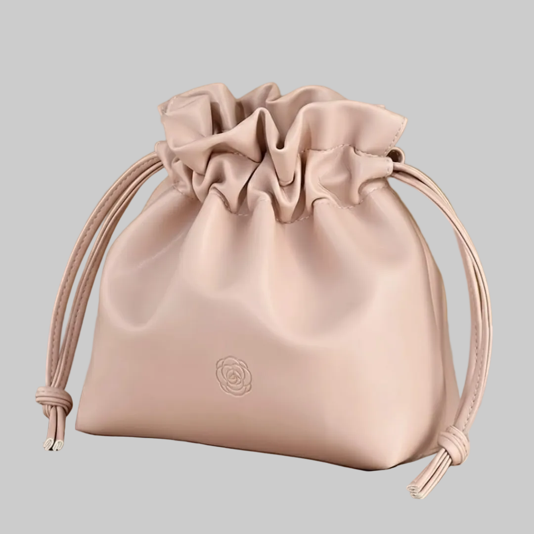 Pink drawstring bag on a beige background with 'Boundless' branding.