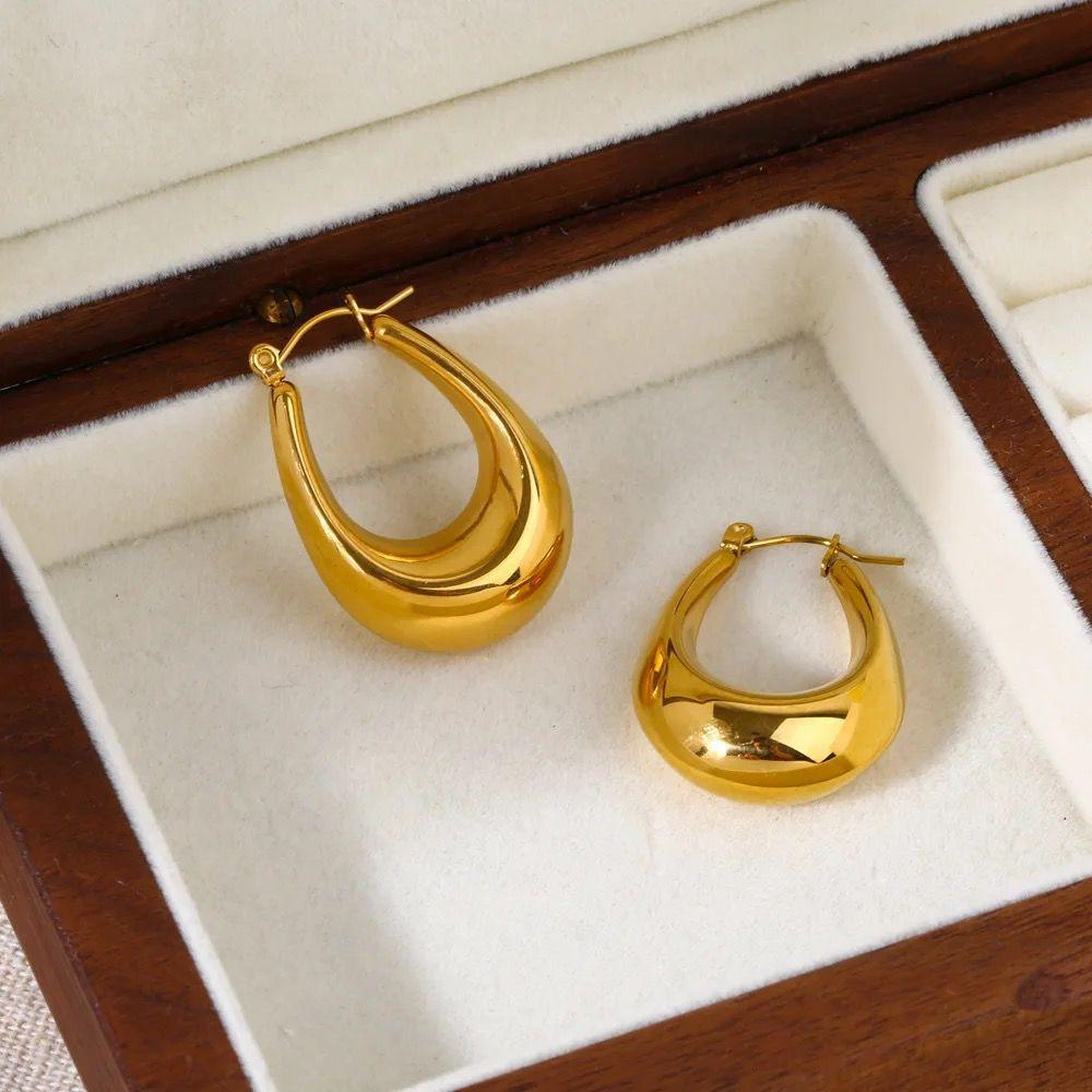 Gold hoop earrings in a jewelry box