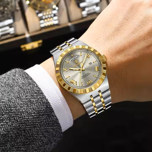 Two-tone watch with silver and gold accents on a wrist, with a blurred background of a jewelry box.