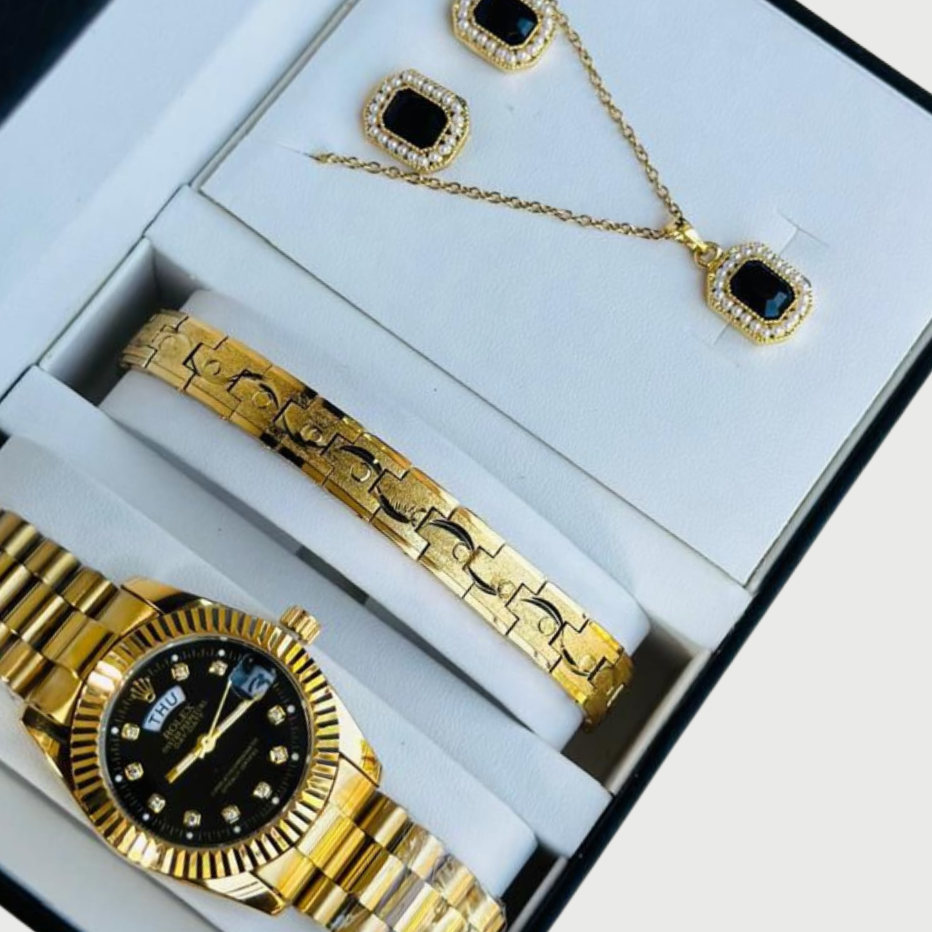 Gold watch, bracelet, and necklace set in a box