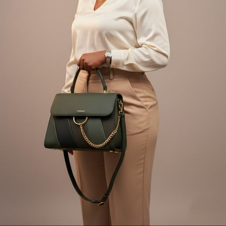 Woman holding a green handbag against a plain background