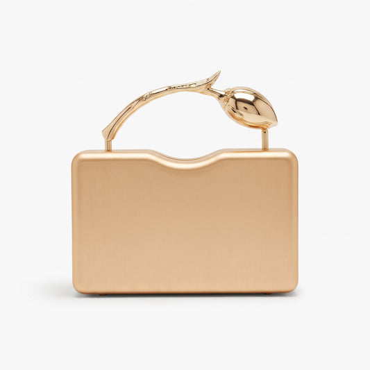 A metallic rose gold evening clutch bag with a rectangular body and a decorative handle shaped like a stylized bird perched on a branch, set against a plain white background.