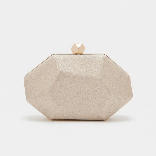 A faceted octagonal clutch bag in a textured champagne beige finish with a small gold geometric clasp on top, set against a plain white background.