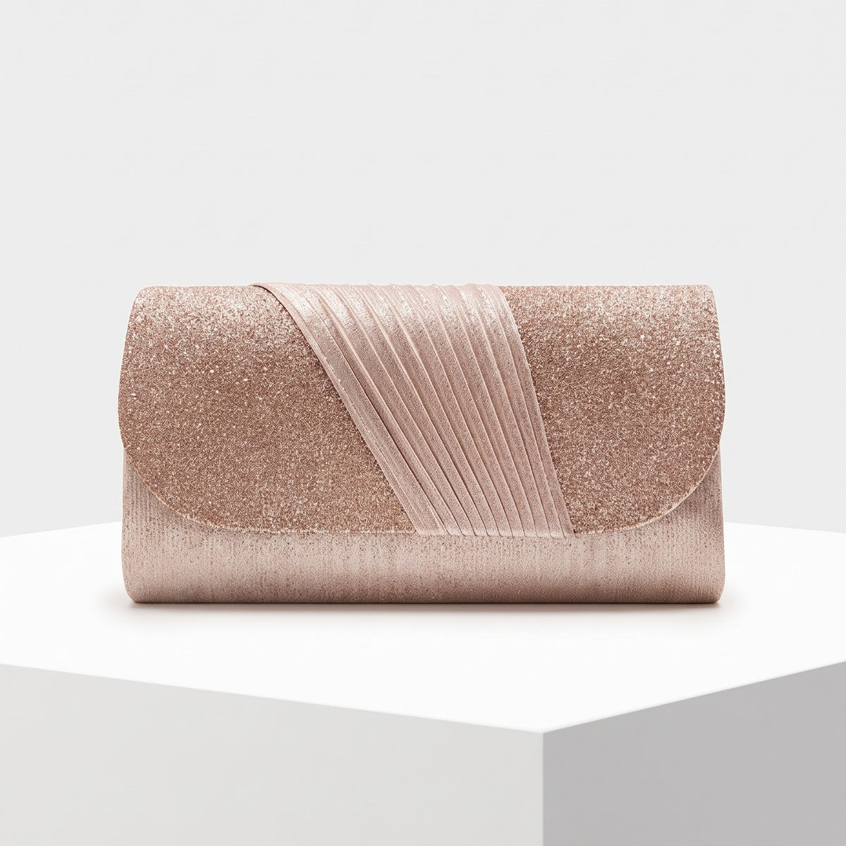 A rose gold glitter clutch bag with a pleated diagonal strap detail, displayed on a white pedestal against a light gray background.