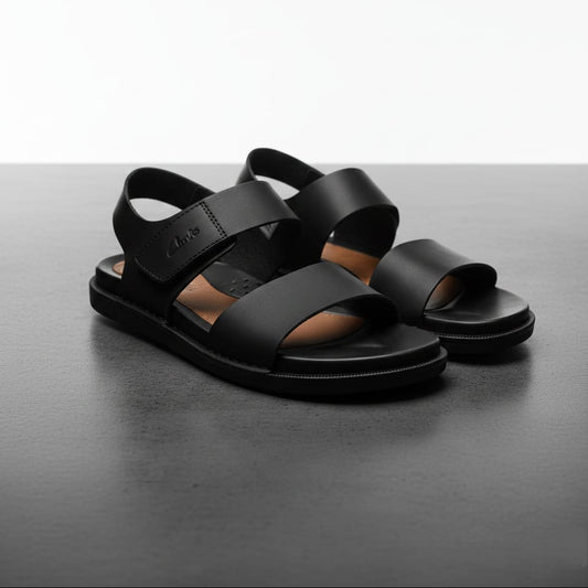 Black sandals on a dark gray surface