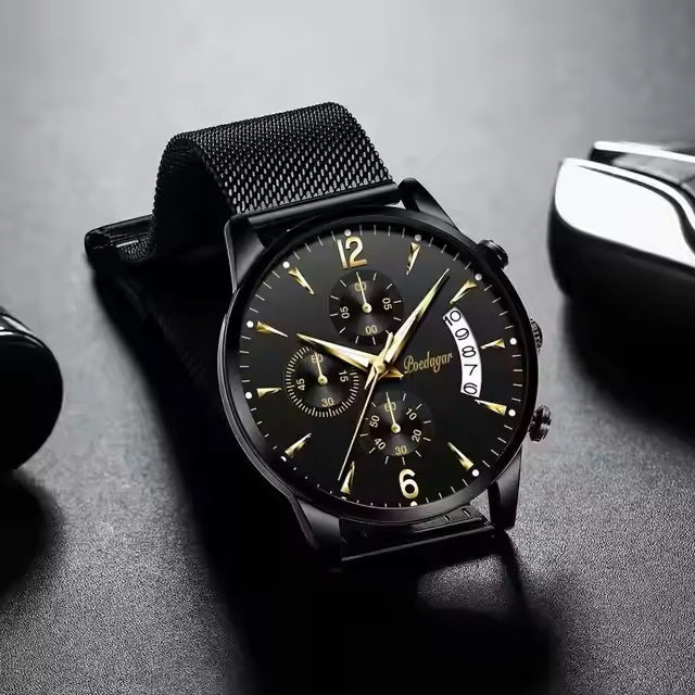 Black watch with gold accents on a gray surface