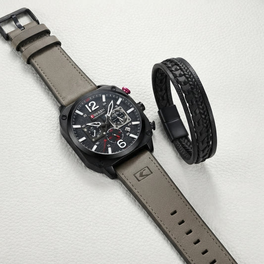 A men's wristwatch with a taupe-gray leather strap and a black skeleton dial, shown alongside a matching black braided leather bracelet on a light textured background.